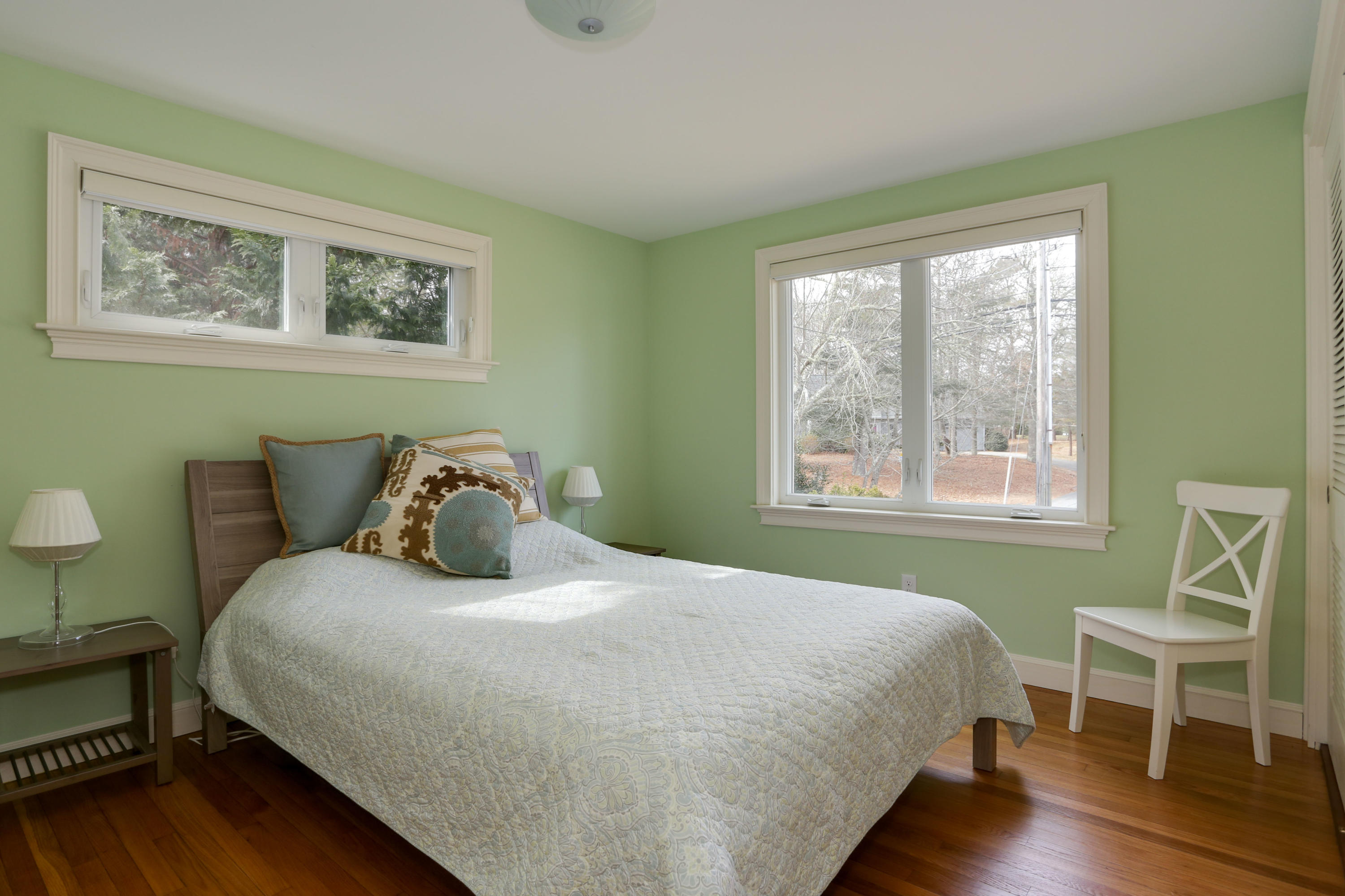 1153 Bumps River Road Centerville, MA 02632 - Photo 18 of 29 a bedroom with a bed and a chair