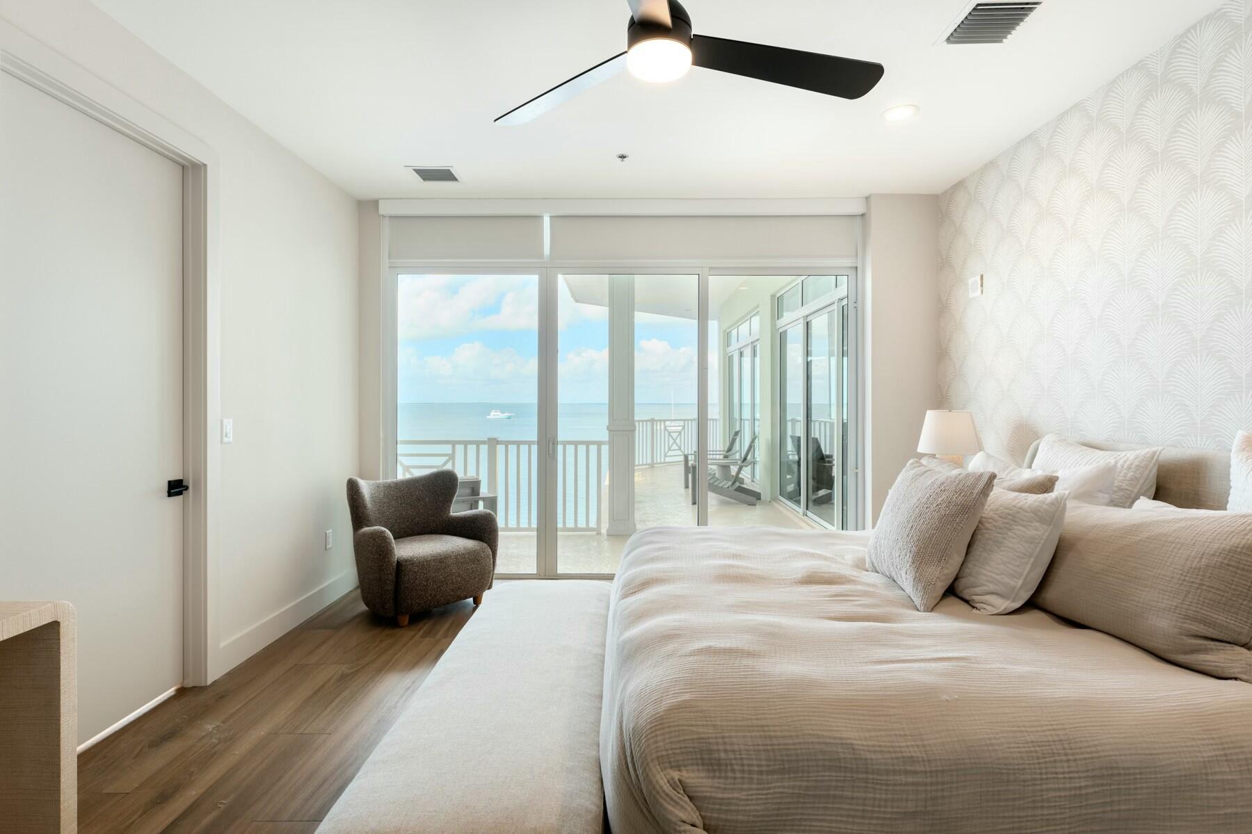 104000 Overseas Highway, Unit 5 Key Largo, FL 33037 - Photo 17 of 60 a spacious bedroom with a bed and glass window