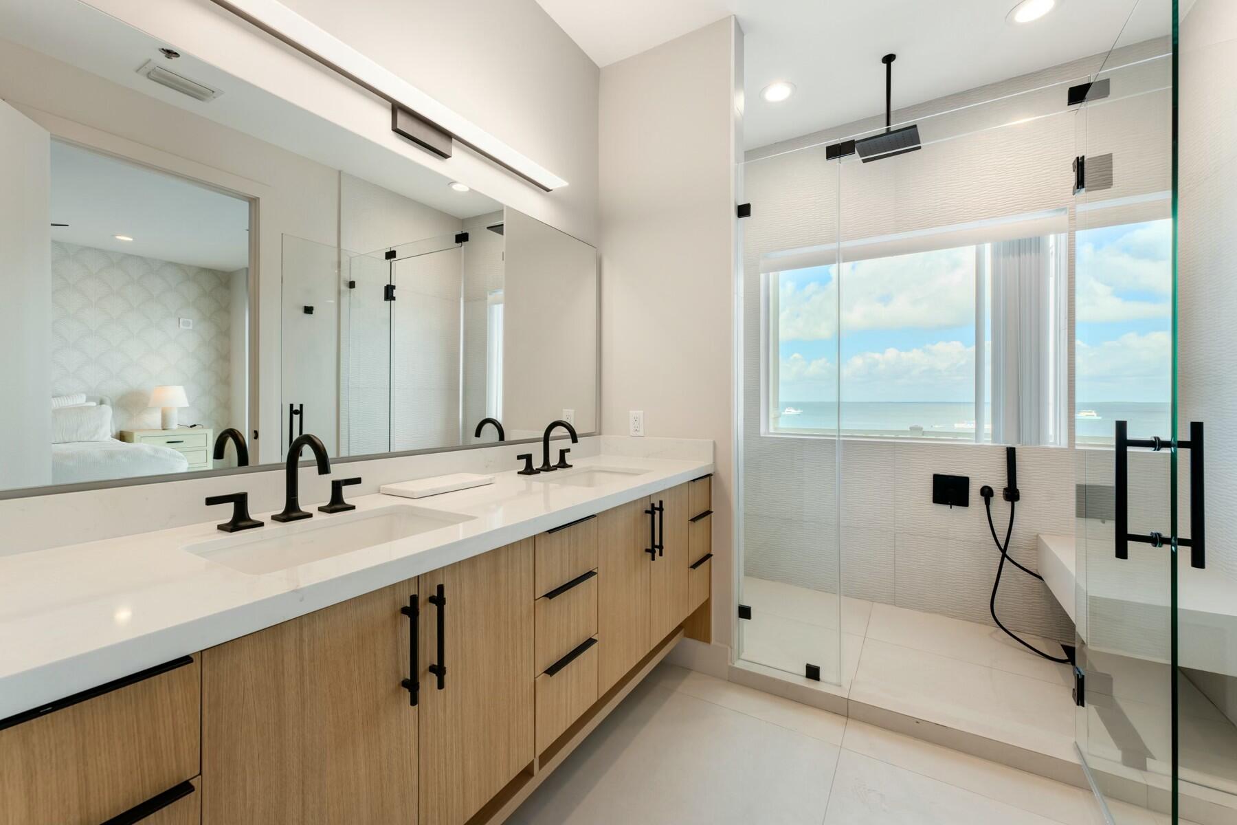 104000 Overseas Highway, Unit 5 Key Largo, FL 33037 - Photo 18 of 60 a bathroom with a double vanity sink mirror and shower