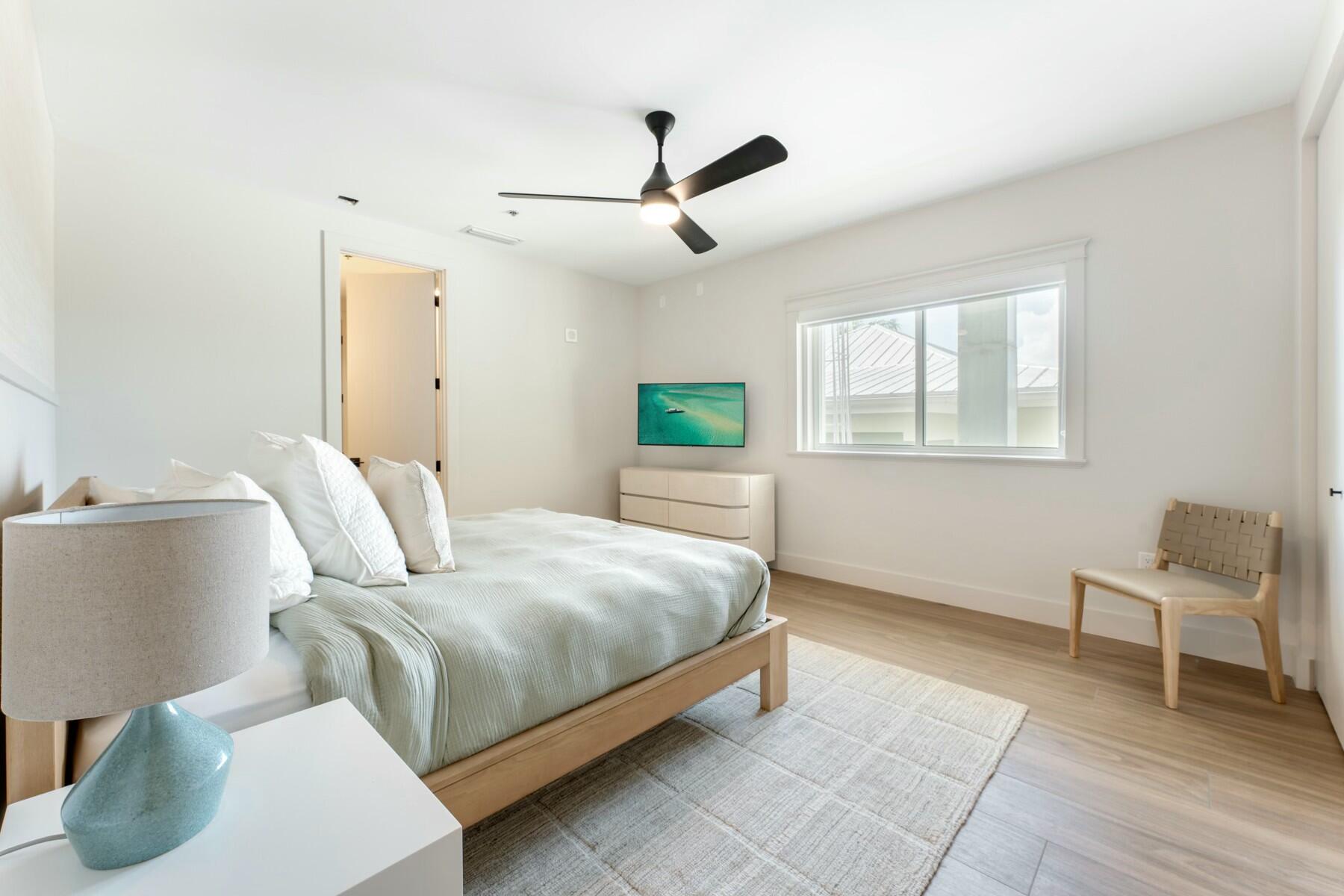 104000 Overseas Highway, Unit 5 Key Largo, FL 33037 - Photo 20 of 60 a bedroom with a bed and window