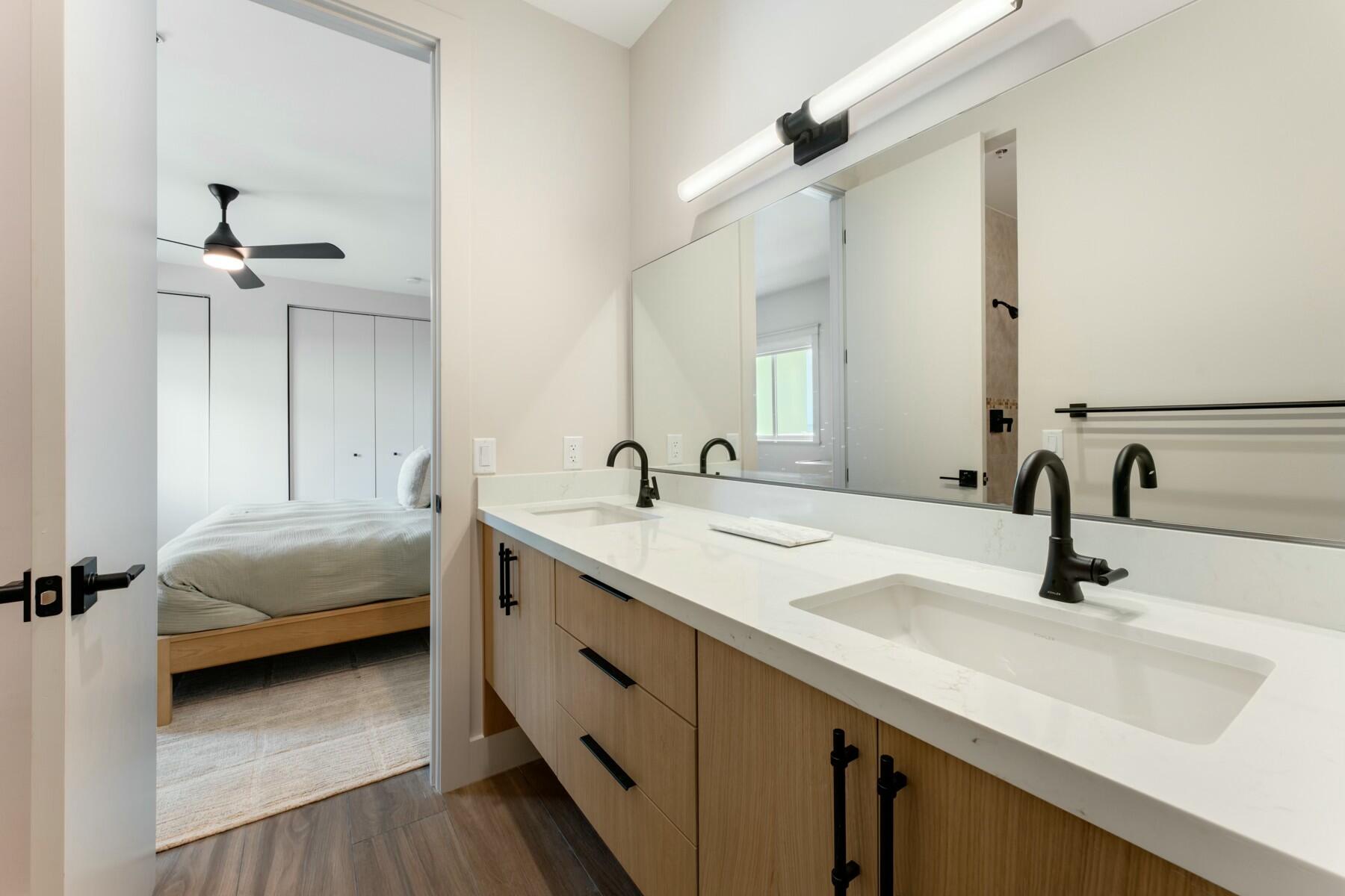 104000 Overseas Highway, Unit 5 Key Largo, FL 33037 - Photo 23 of 60 a en suite bathroom with double vanity sinks and a mirror