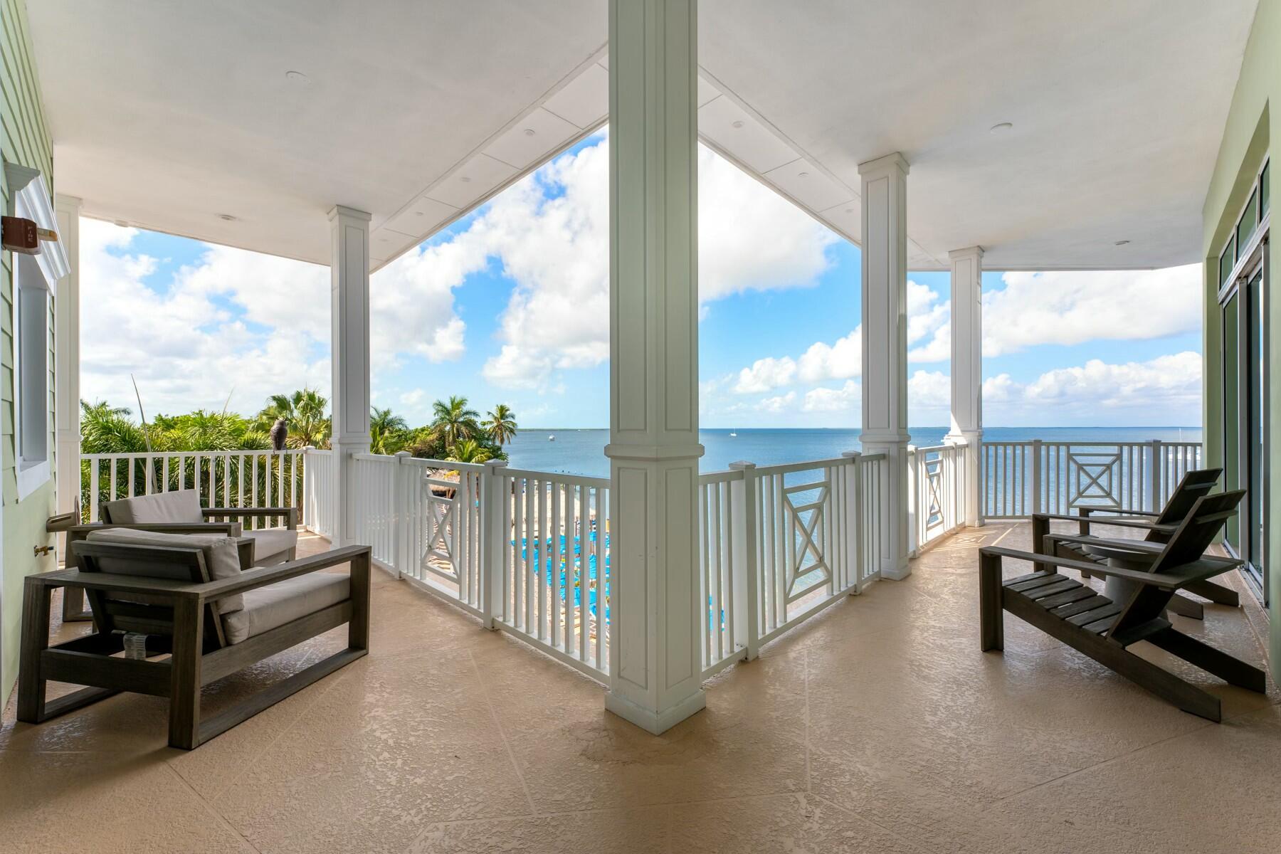 104000 Overseas Highway, Unit 5 Key Largo, FL 33037 - Photo 27 of 60 a view of a porch with furniture and floor to ceiling window
