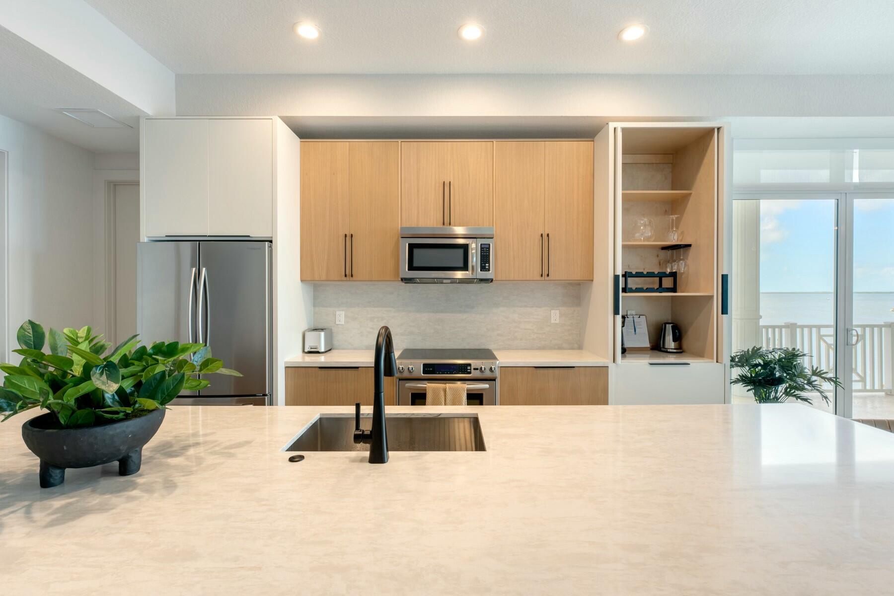 104000 Overseas Highway, Unit 5 Key Largo, FL 33037 - Photo 4 of 60 a living room with furniture potted plant and a window