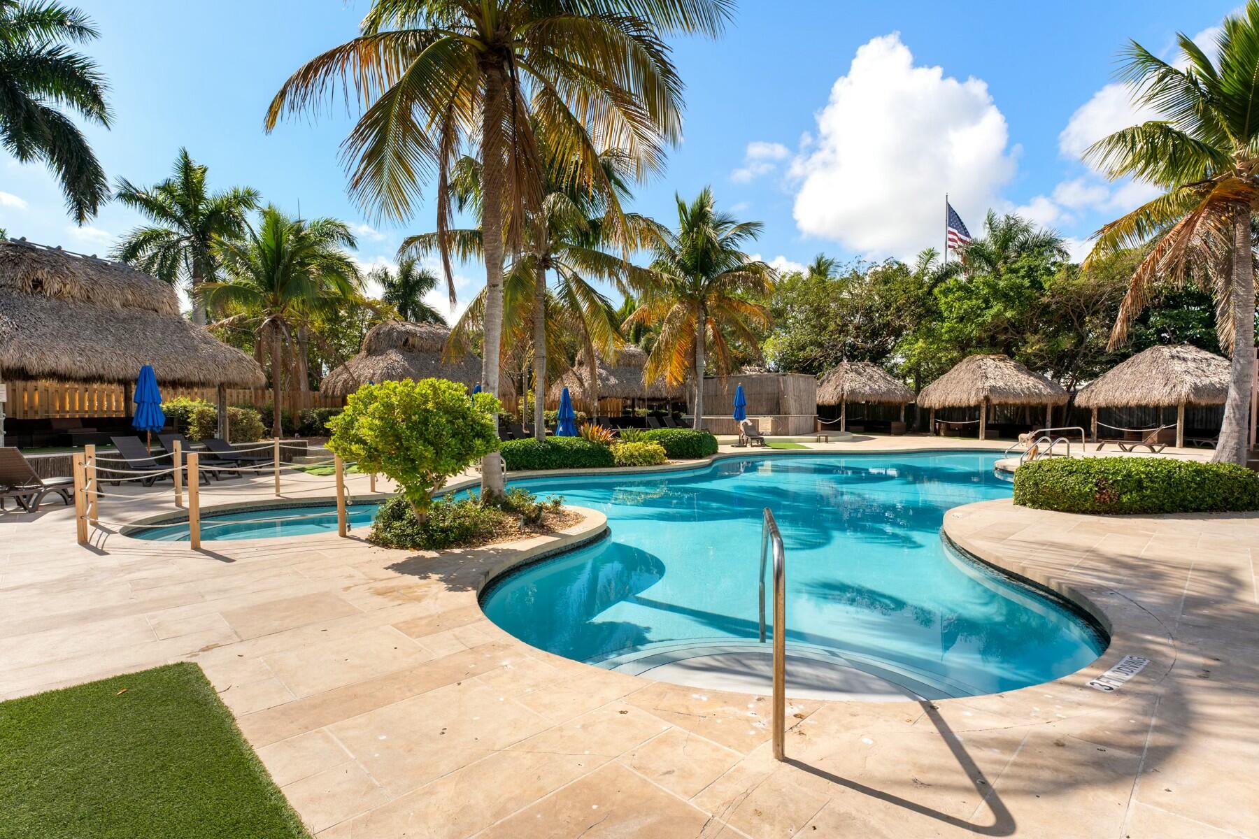 104000 Overseas Highway, Unit 5 Key Largo, FL 33037 - Photo 41 of 60 a view of a backyard with plants and palm tree