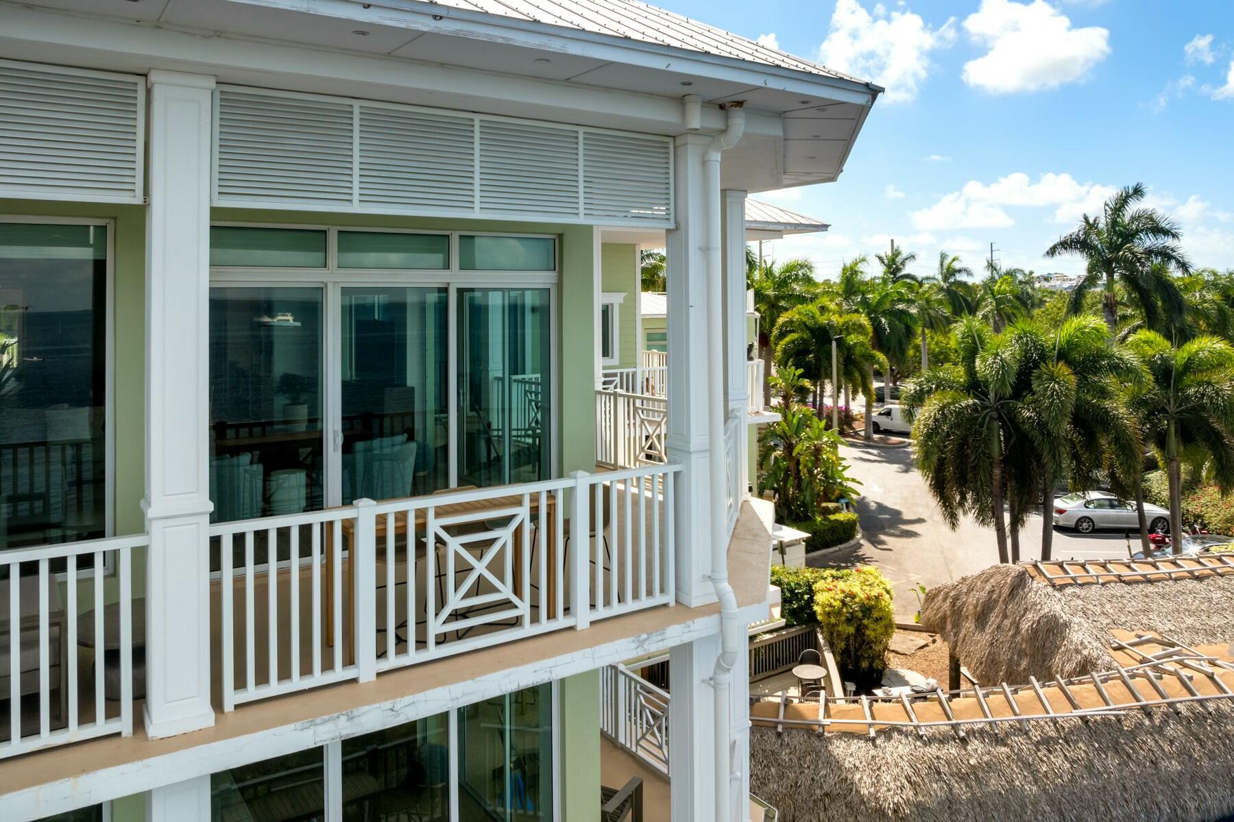 104000 Overseas Highway, Unit 5 Key Largo, FL 33037 - Photo 51 of 60 a view of a house with a small yard and plants