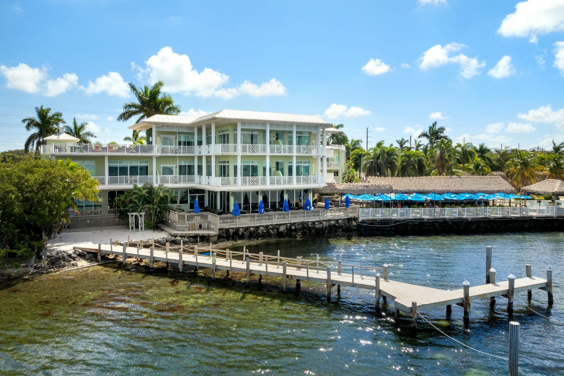 104000 Overseas Highway, Unit 5 Key Largo, FL 33037 - Photo 54 of 60 a view of a lake with a house in the background