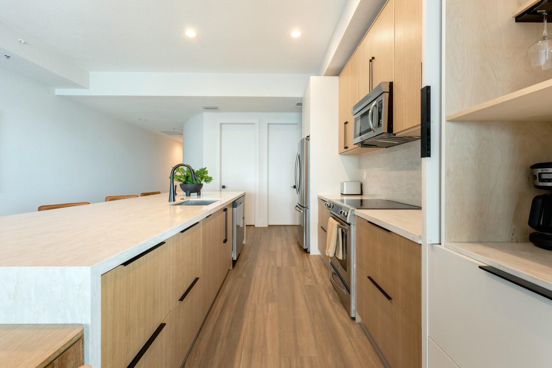 104000 Overseas Highway, Unit 5 Key Largo, FL 33037 - Photo 6 of 60 a kitchen with stainless steel appliances a sink and a stove