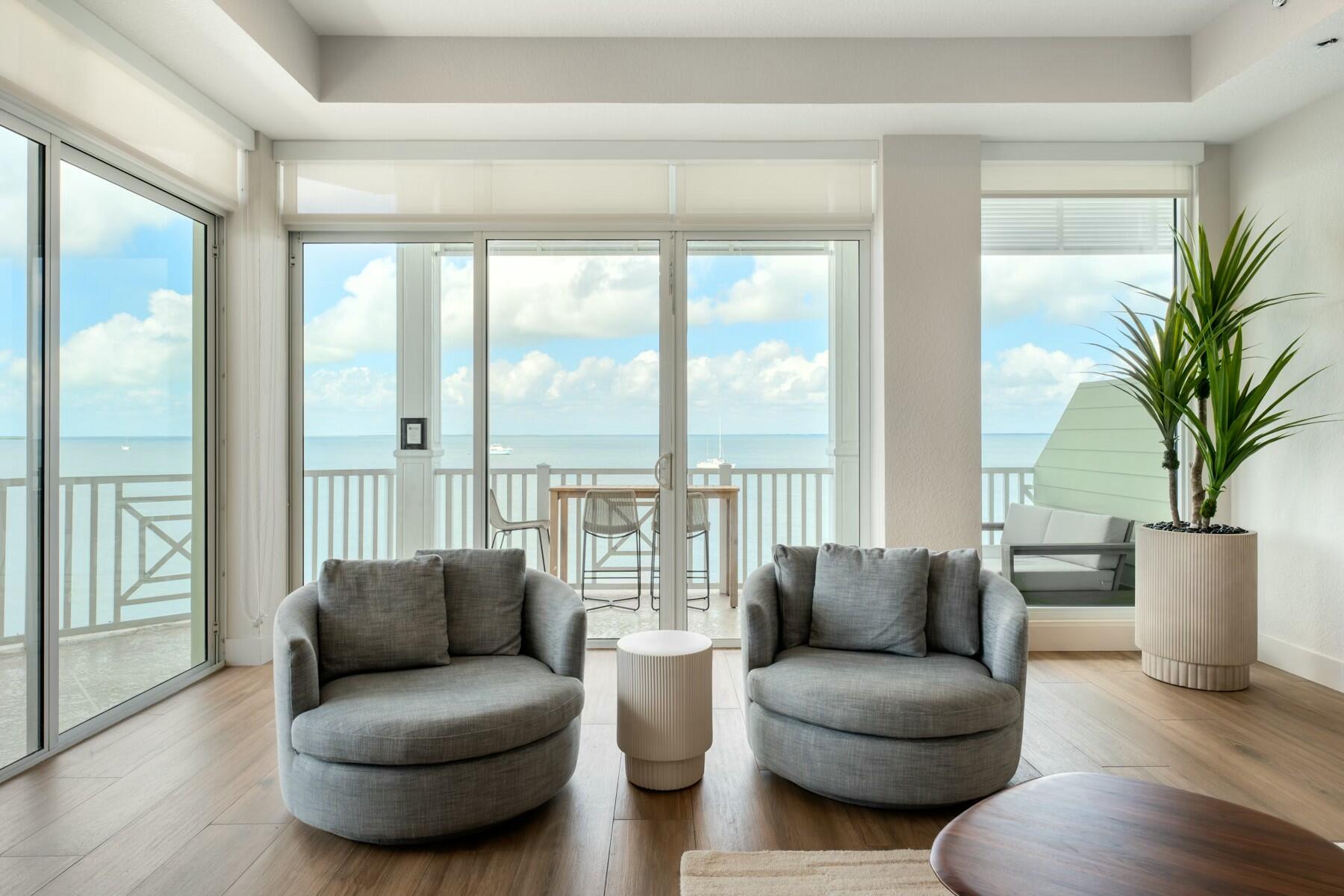 104000 Overseas Highway, Unit 5 Key Largo, FL 33037 - Photo 10 of 60 a living room with furniture and a large window with outer view