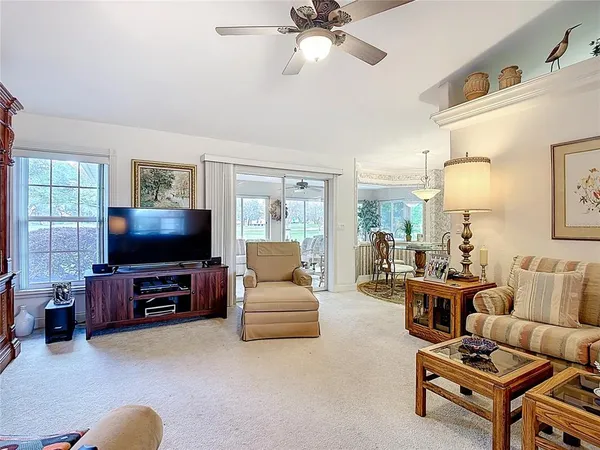 a living room with furniture gym equipment and a chandelier