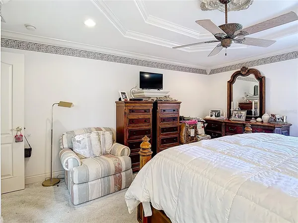 an empty room with a fan & a window