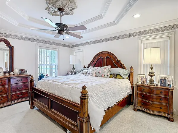 an empty room with wooden floor fan and a window