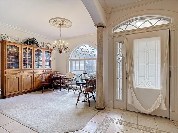 a living room with furniture a fireplace and a chandelier