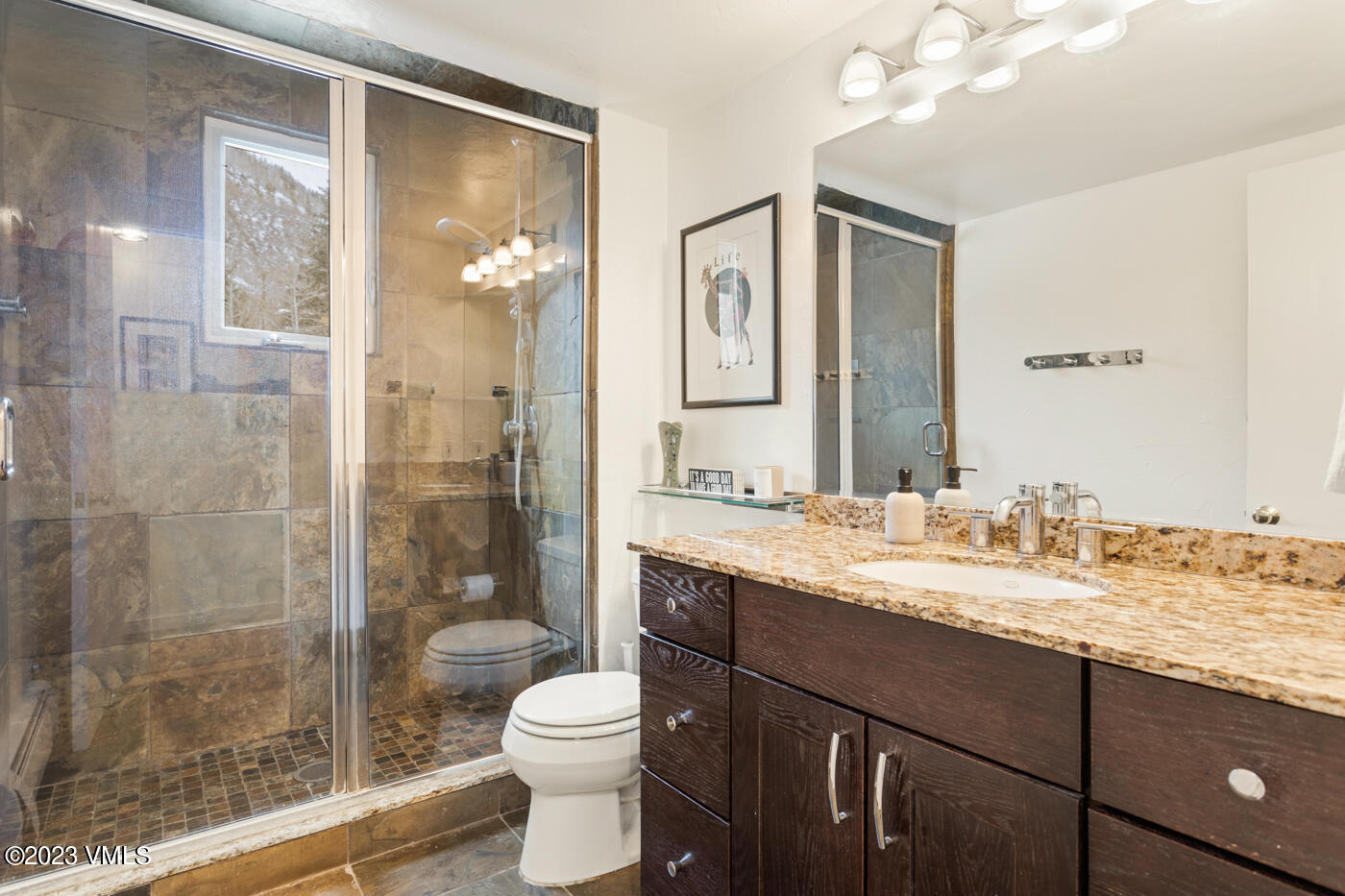1880 Meadow Ridge Road, Unit 9 Vail, CO 81657 - Photo 16 of 24 a bathroom with a granite countertop sink toilet a mirror and shower