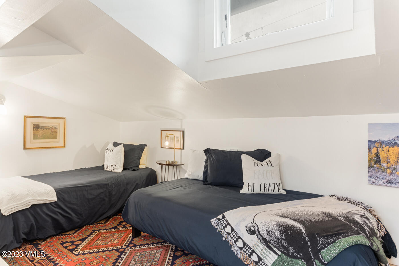 1880 Meadow Ridge Road, Unit 9 Vail, CO 81657 - Photo 18 of 24 a bedroom with two beds and painting on the wall