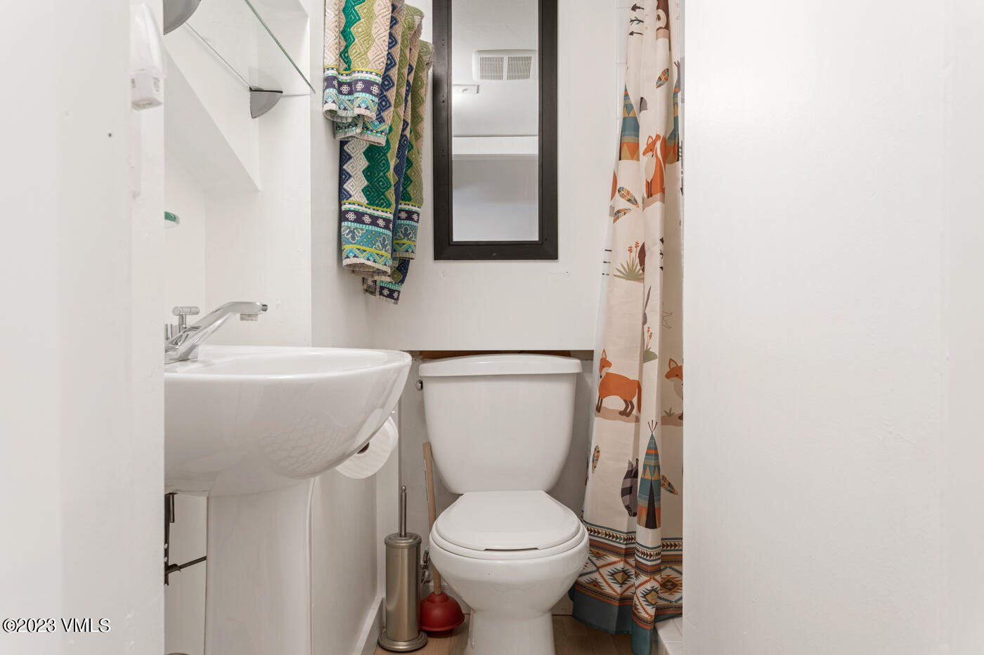 1880 Meadow Ridge Road, Unit 9 Vail, CO 81657 - Photo 22 of 24 a bathroom with a toilet sink and mirror