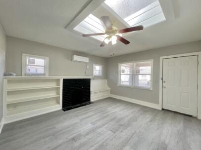 2315 15th Street Lubbock, TX 79401 - Photo 2 of 10 a view of an empty room with a window and a kitchen
