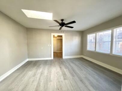 2315 15th Street Lubbock, TX 79401 - Photo 3 of 10 an empty room with wooden floor and windows