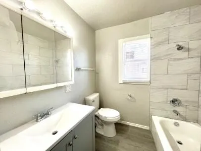 a bathroom with a bathtub a sink a toilet and a shower