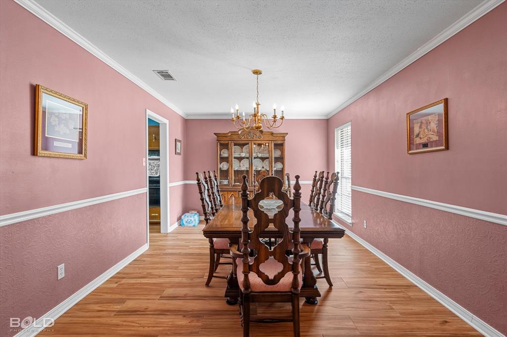 8543 Sac Fox Road Shreveport, LA 71107 - Photo 12 of 35 a view of a dining room with furniture window and wooden floor