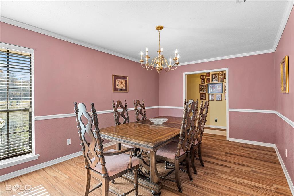 8543 Sac Fox Road Shreveport, LA 71107 - Photo 13 of 35 a view of a dining room with furniture and wooden floor