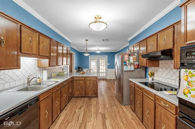 a kitchen with stainless steel appliances granite countertop a sink stove and refrigerator
