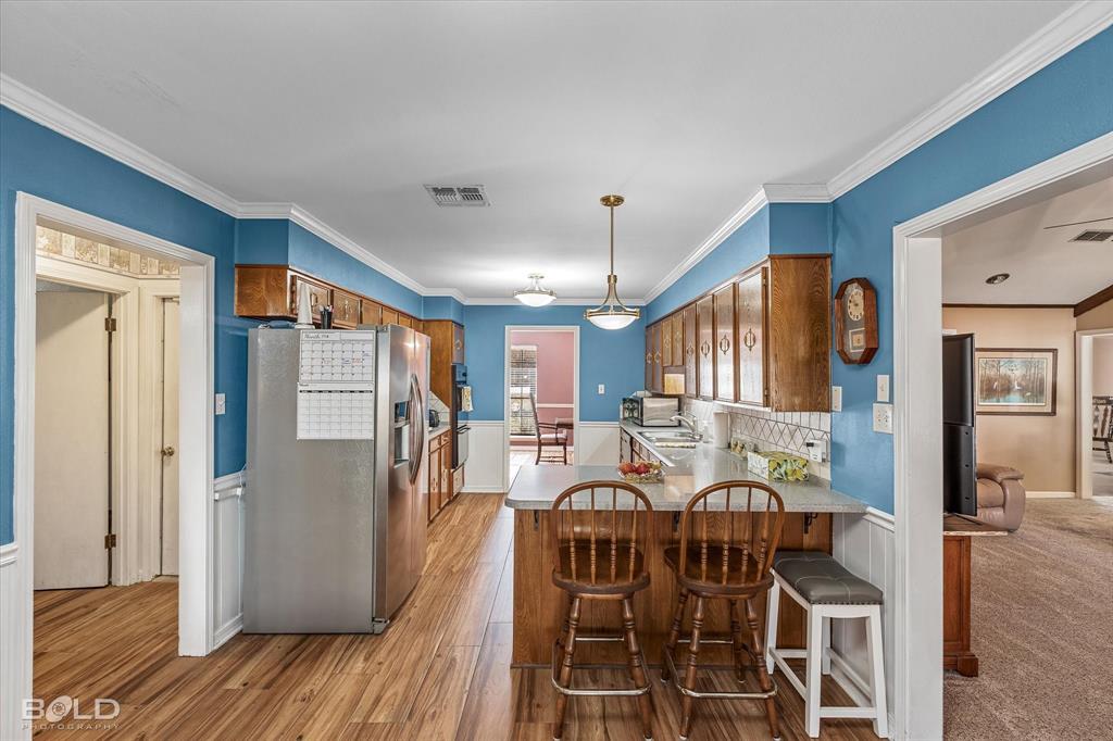 8543 Sac Fox Road Shreveport, LA 71107 - Photo 19 of 35 a view of a dining room with furniture and wooden floor