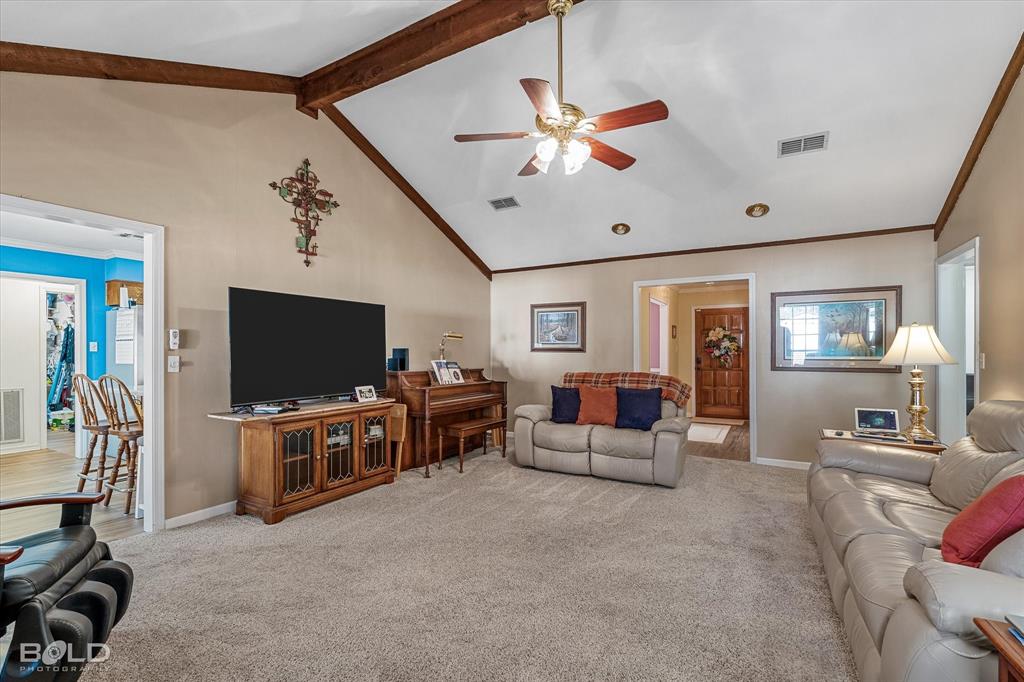 8543 Sac Fox Road Shreveport, LA 71107 - Photo 23 of 35 a living room with furniture and a flat screen tv