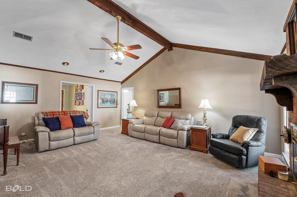 8543 Sac Fox Road Shreveport, LA 71107 - Photo 24 of 35 a living room with furniture a ceiling fan and a window