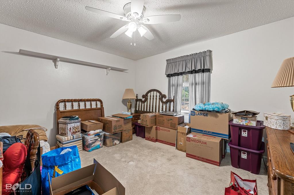 8543 Sac Fox Road Shreveport, LA 71107 - Photo 33 of 35 a bedroom with furniture and a chandelier