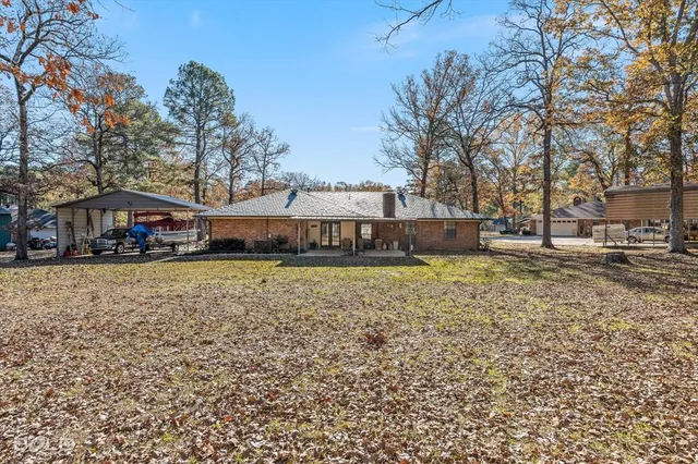 a view of a house with backyard porch and sitting area