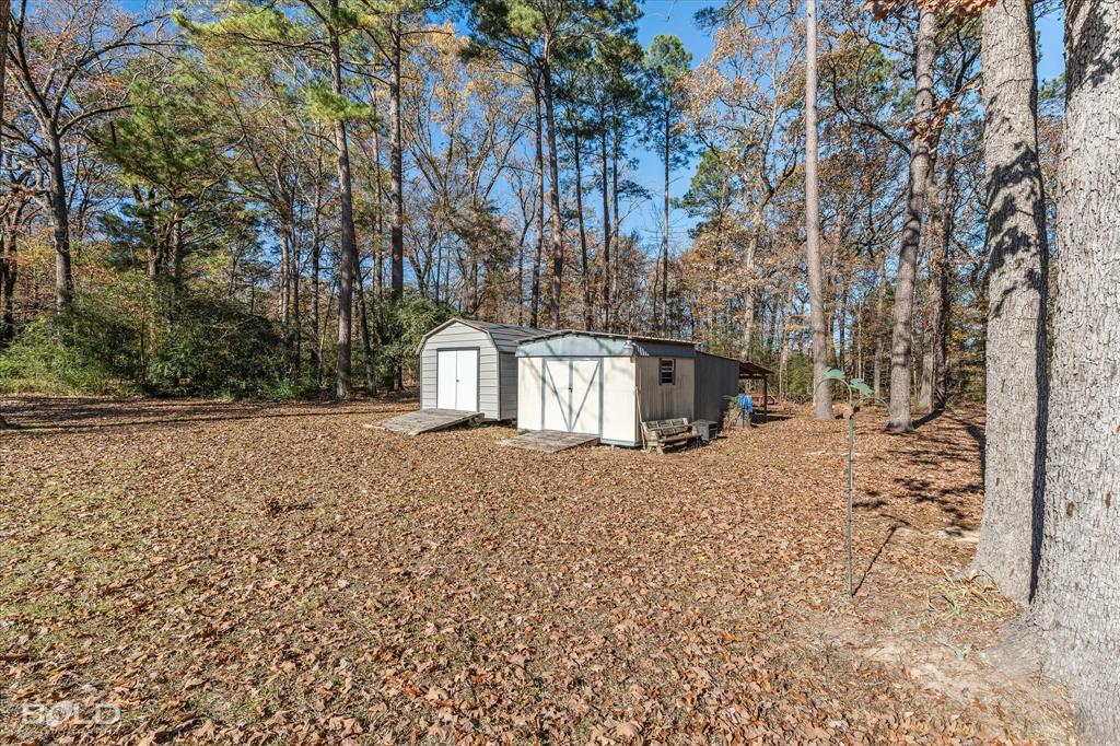 8543 Sac Fox Road Shreveport, LA 71107 - Photo 10 of 35 a view of a house with a yard and tree s