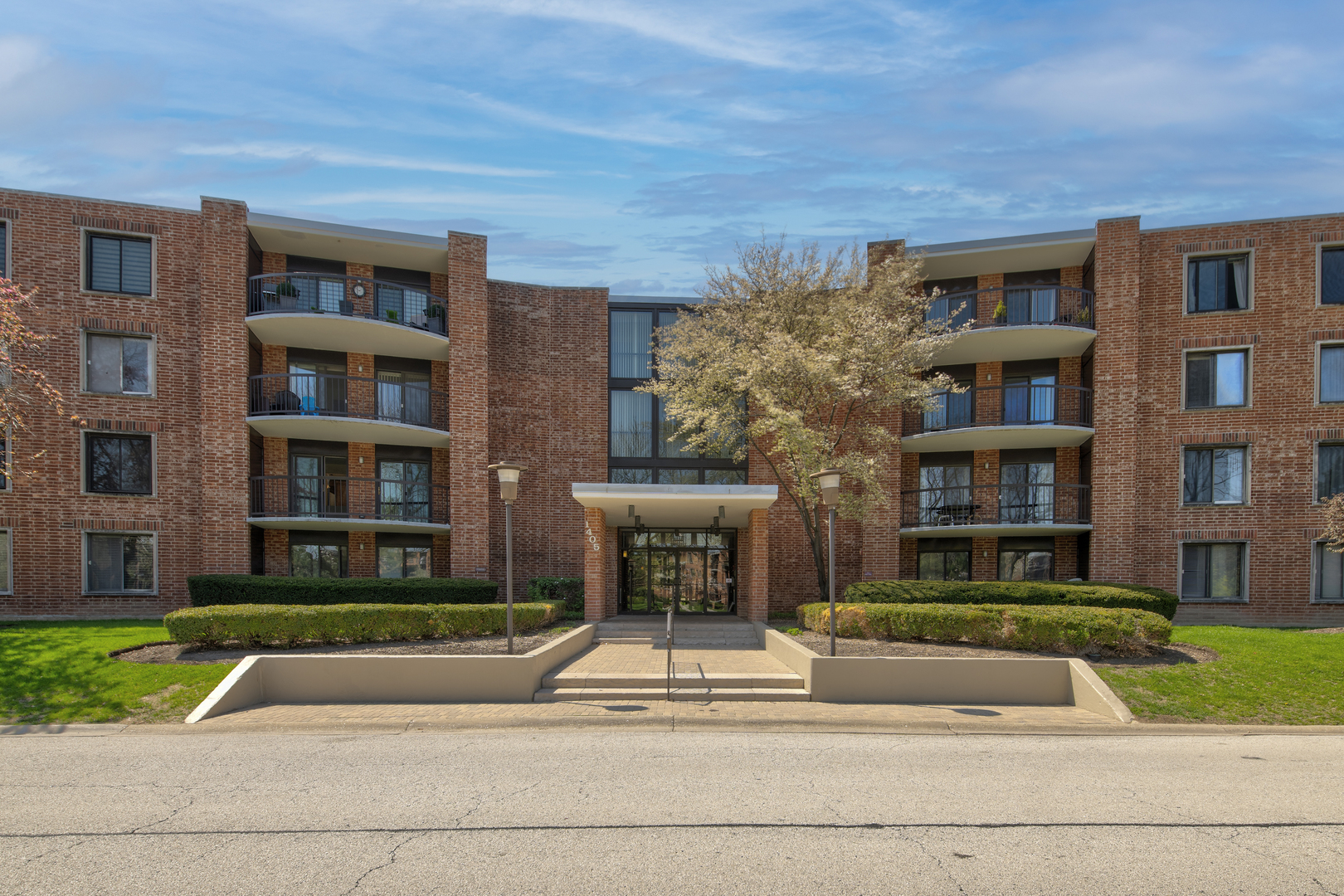 a front view of a building with a yard