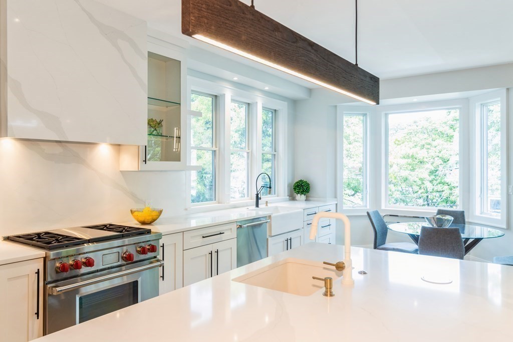 89 University Road Brookline, MA 02445 - Photo 11 of 41 a kitchen with a stove a sink and a refrigerator