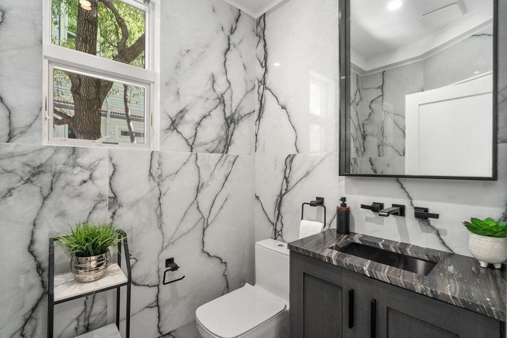 89 University Road Brookline, MA 02445 - Photo 17 of 41 a bathroom with a granite countertop sink and a toilet