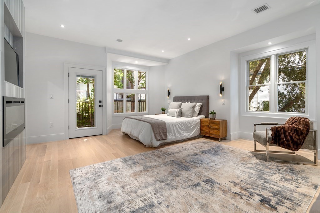 89 University Road Brookline, MA 02445 - Photo 18 of 41 a bedroom with a large bed and a window