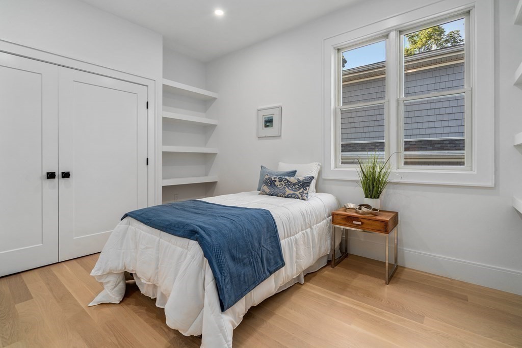 89 University Road Brookline, MA 02445 - Photo 27 of 41 a bedroom with a bed dresser and a window
