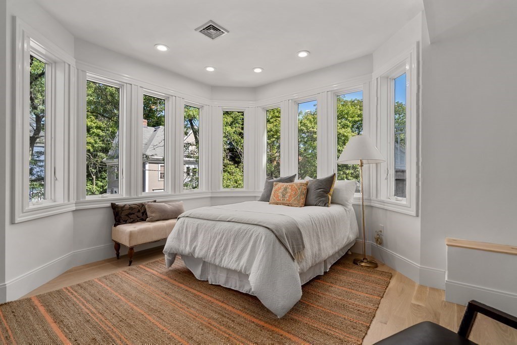 89 University Road Brookline, MA 02445 - Photo 30 of 41 a bedroom with a bed and a large window