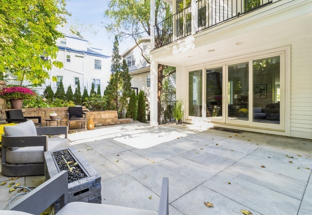 89 University Road Brookline, MA 02445 - Photo 38 of 41 a view of a patio with couches table and chairs and potted plants