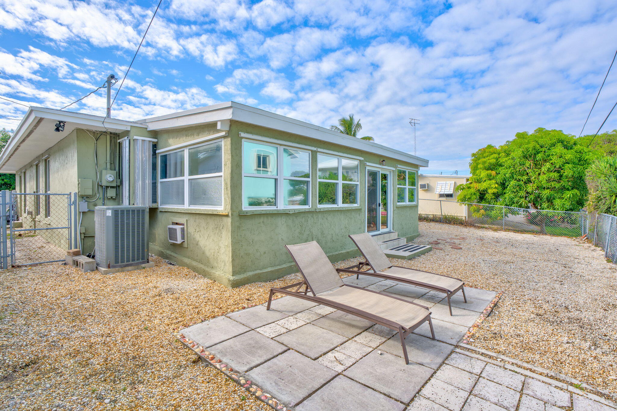 304 2nd Terrace Key Largo, FL 33037 - Photo 34 of 43 a view of a patio with a table and chairs and potted plants