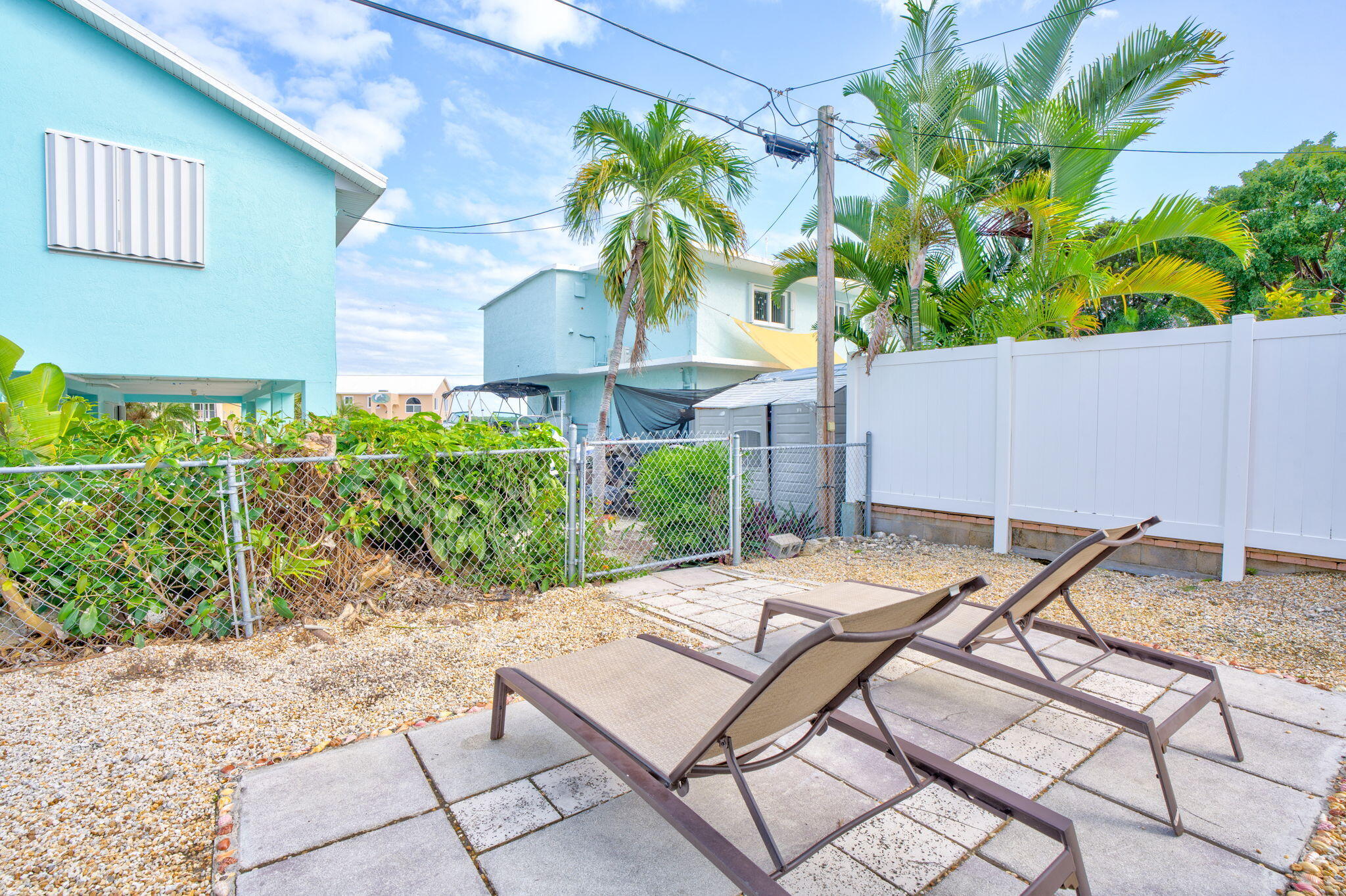 304 2nd Terrace Key Largo, FL 33037 - Photo 35 of 43 a backyard of a house with table and chairs