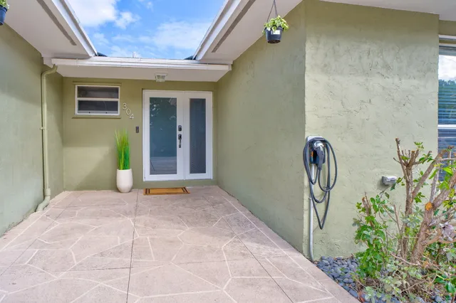 a kitchen with granite countertop white cabinets and sink