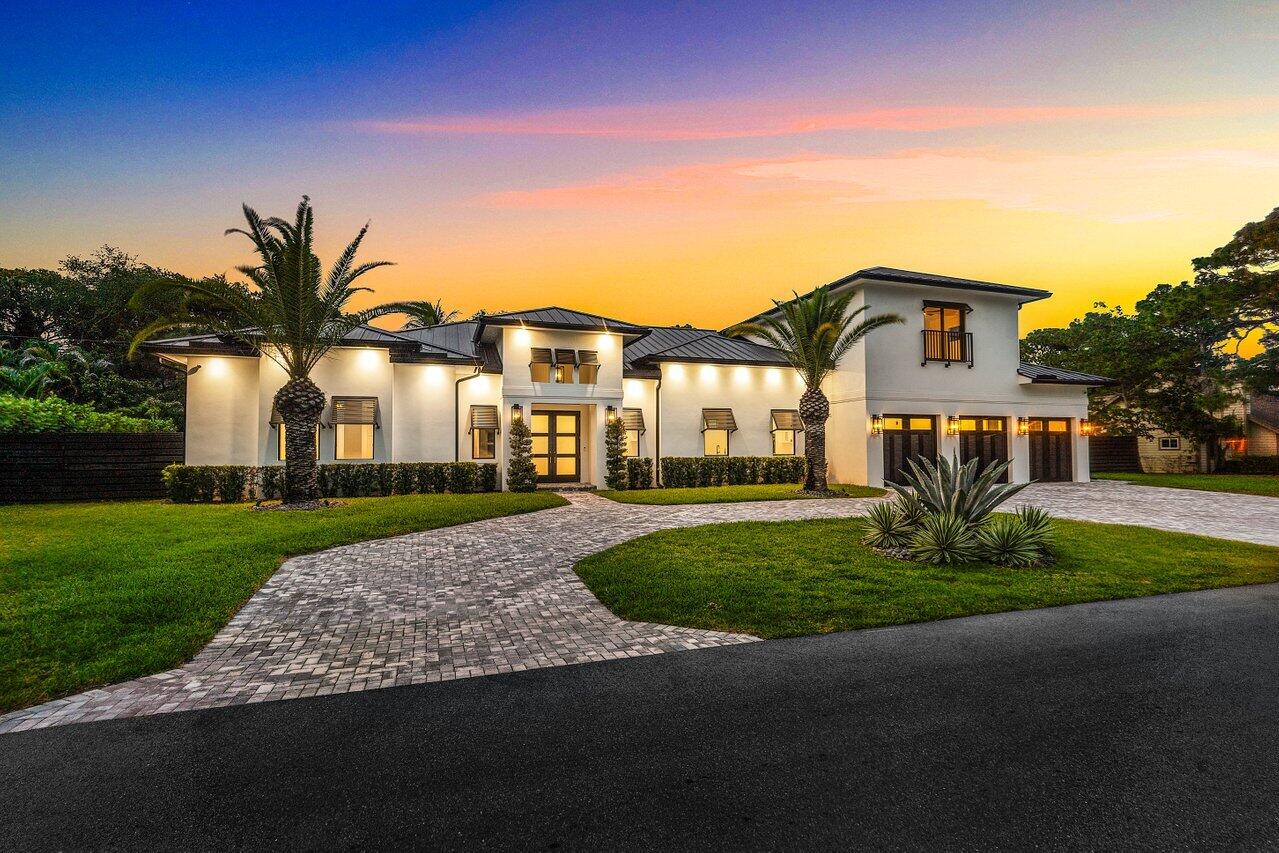 5701 Old Orange Road Jupiter, FL 33458 - Photo 1 of 46 a front view of a house with a yard and garage