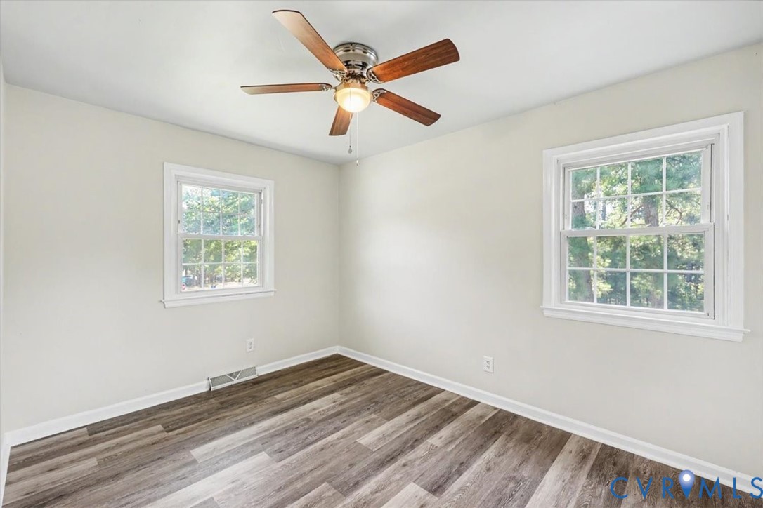 9737 Graves Road Petersburg, VA 23803 - Photo 18 of 41 Wood-finish flooring, two large windows, white wal