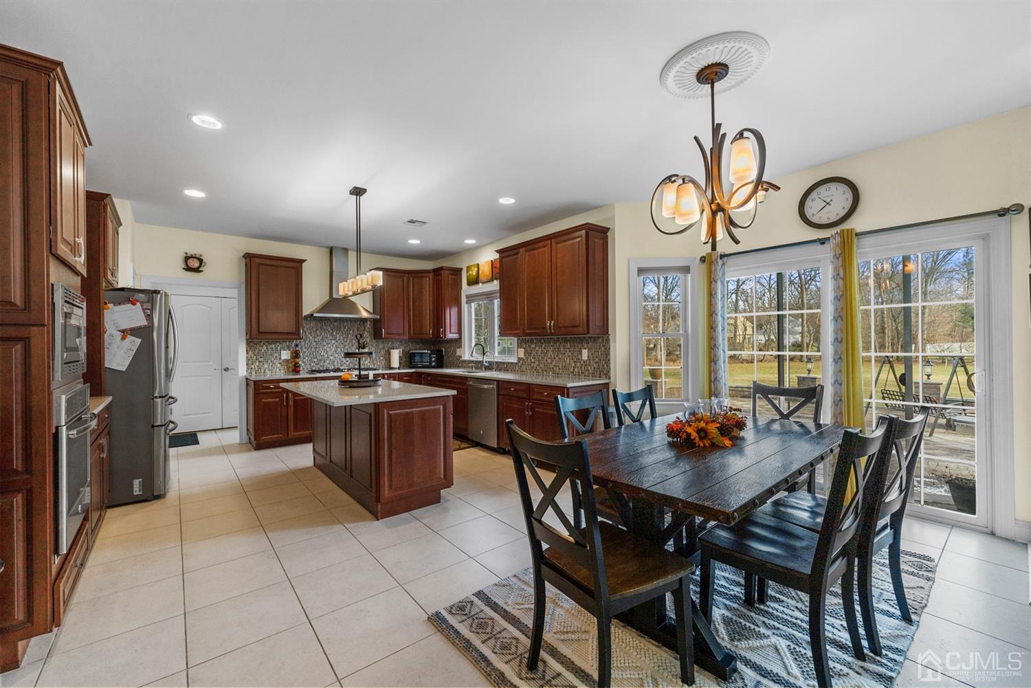 308 Plainfield Road Edison, NJ 08820 - Photo 23 of 40 a kitchen with a dining table chairs and refrigerator