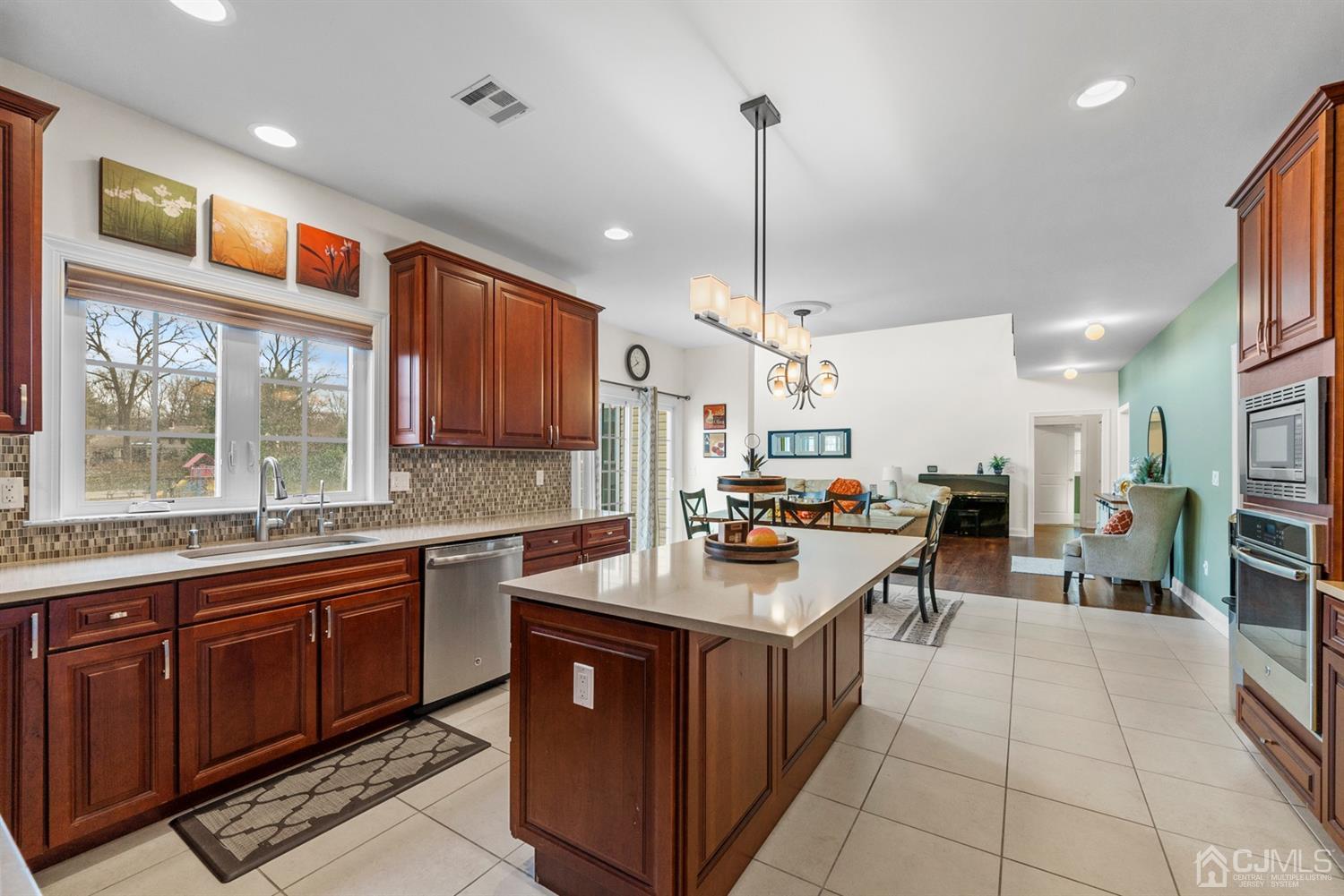 308 Plainfield Road Edison, NJ 08820 - Photo 25 of 40 a kitchen with a sink stove and wooden cabinets