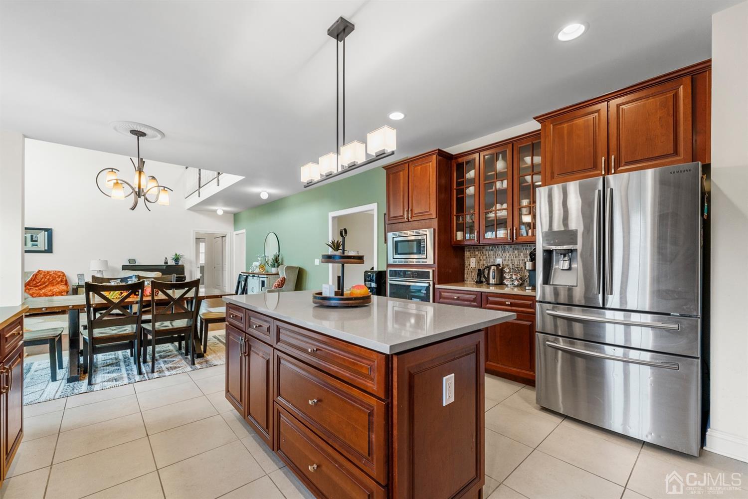 308 Plainfield Road Edison, NJ 08820 - Photo 26 of 40 a kitchen with stainless steel appliances granite countertop a refrigerator a sink dishwasher a dining table and chairs with wooden floor