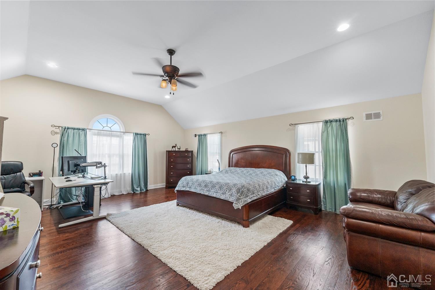 308 Plainfield Road Edison, NJ 08820 - Photo 37 of 40 a bedroom with a bed couch chandelier windows and wooden floor