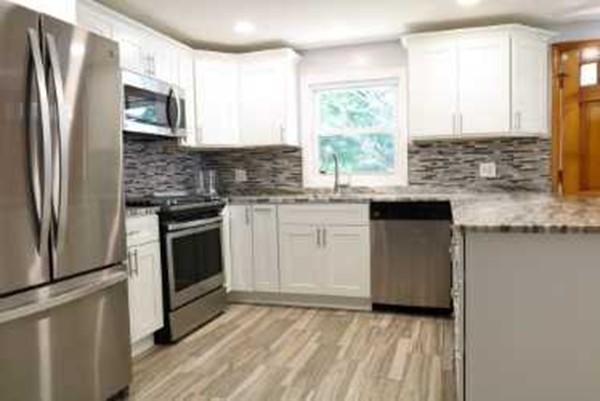 1 Standish Road Lawrence, MA 01843 - Photo 2 of 13 a kitchen with granite countertop a sink stainless steel appliances and window