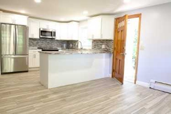 1 Standish Road Lawrence, MA 01843 - Photo 3 of 13 a kitchen with stainless steel appliances granite countertop a refrigerator and a stove top oven