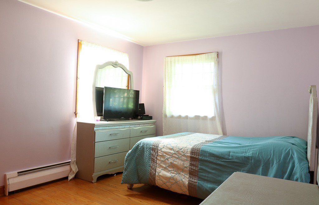 1 Standish Road Lawrence, MA 01843 - Photo 9 of 13 a bedroom with a bed and a flat screen tv